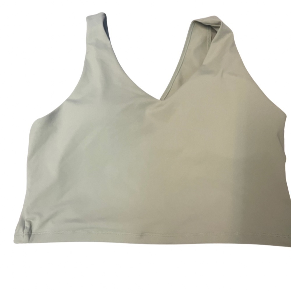 Light green sports bra/crop top, you decide. Cross cross back and thick straps.